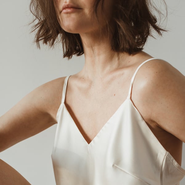 Woman Wearing White Tank Top on White Studio Background